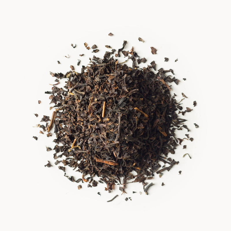A pile of Rishi Tea & Botanicals English Breakfast on a white background.