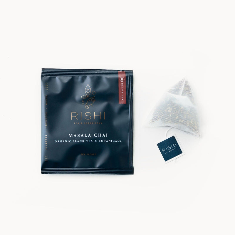 A bag of Rishi Tea & Botanicals Masala Chai with a tea bag next to it.