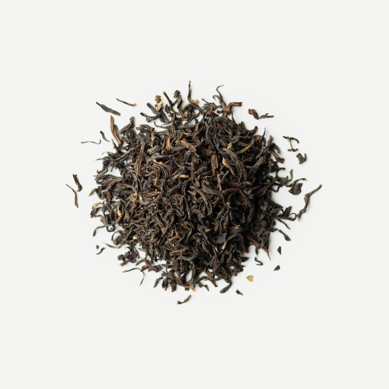 A pile of Darjeeling Second Flush Lingia DJ42 from the Rishi Tea & Botanicals estate rests against a plain white background.