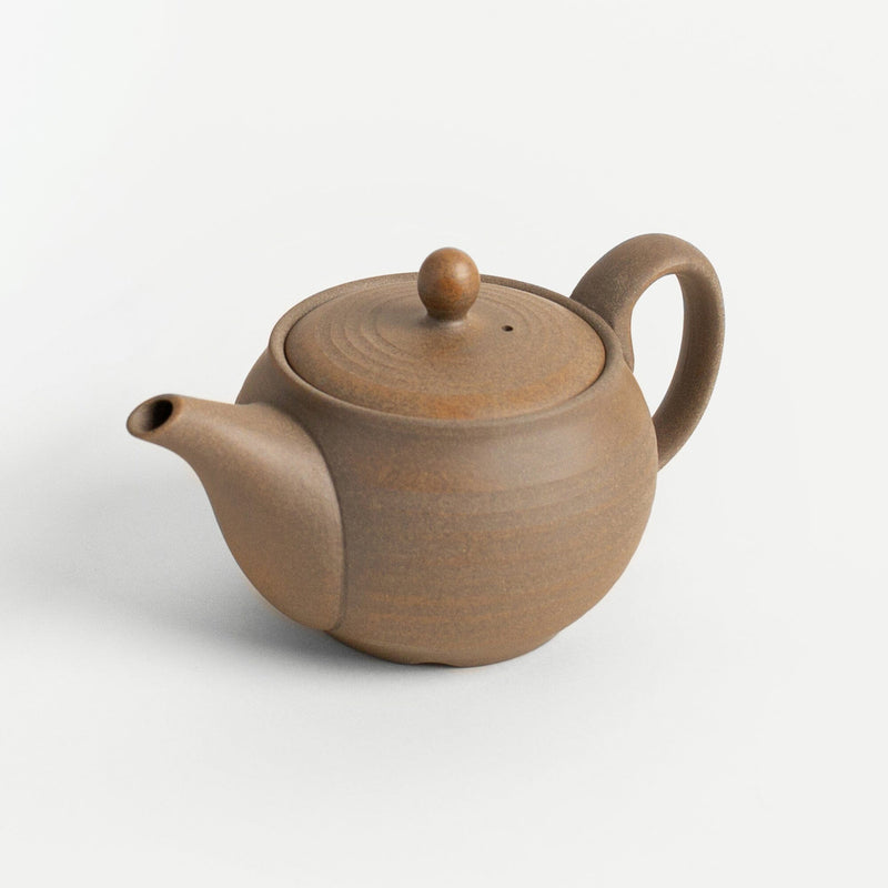 Brown ceramic teapot on a white background