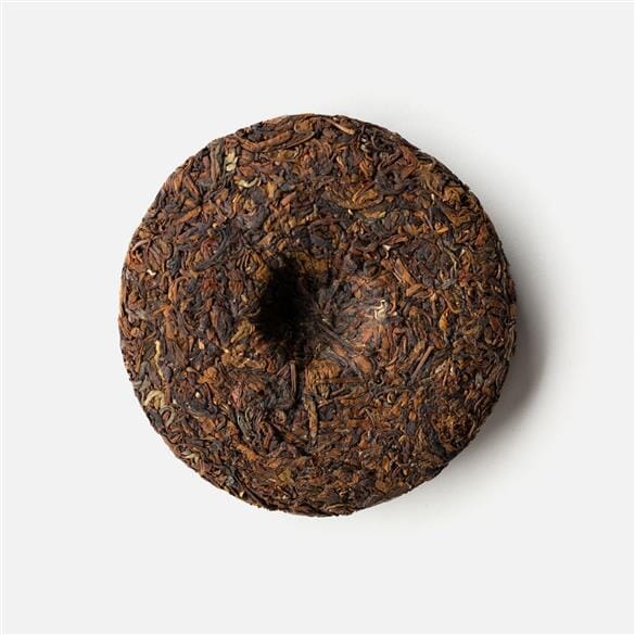 A Doi Wawee Shaihong Spring Cake by Rishi Tea & Botanicals on a white background.